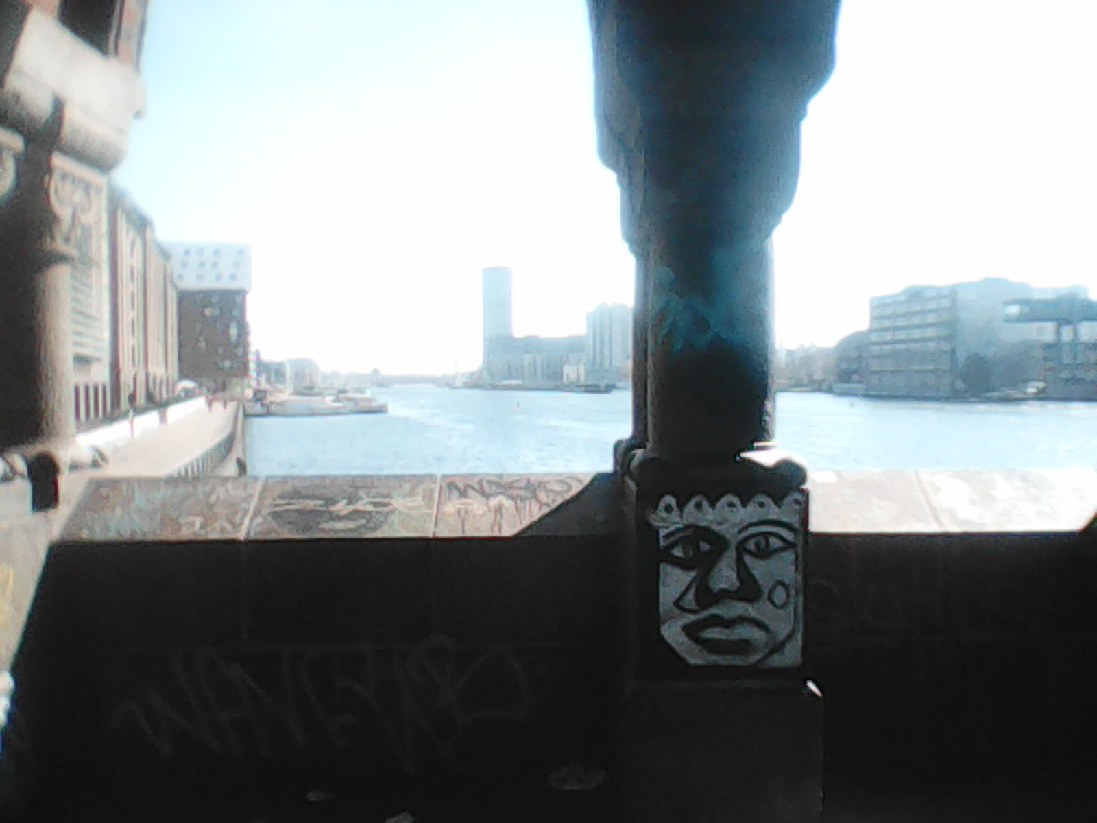 A face painted on a pillar of a bridge.